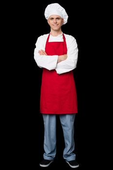 Image of a smiling young male chef posing confidently