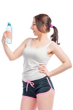 young woman in shorts and a t-shirt with a water bottle