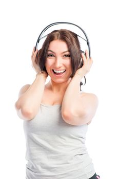 brunette with headphones listening to music on a white background
