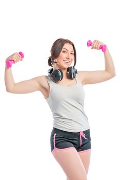 Trainer with a dumbbell and headphones on a white background