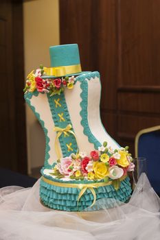 beautiful turquoise wedding cake with hat on it.