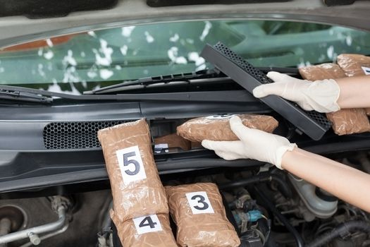 Drug smuggled in a car engine compartment. Drug stash spot.