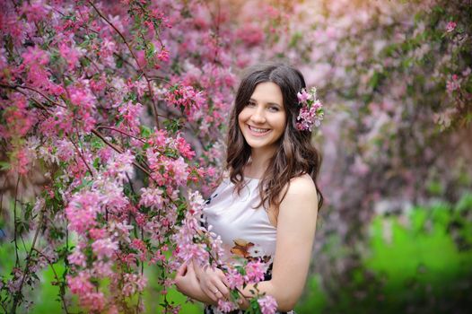 smiling brunette woman in the park on a warm summer day.