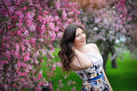 beautiful brunette woman in the park in spring