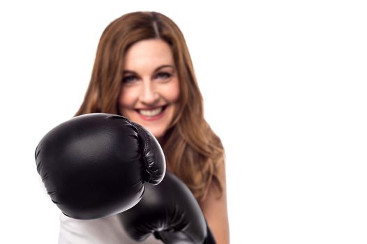 Pretty woman wearing boxing gloves ready to fight