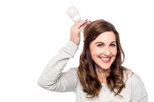 Beautiful woman with bulb over her head