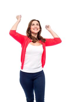 Cheerful woman celebrating with arms up.