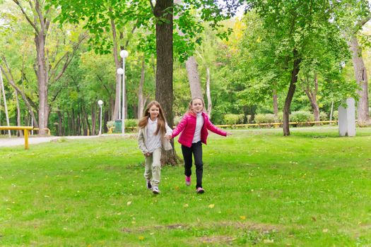 Photo of cute two running girls in summer