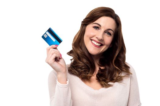 Happy smiling woman showing her credit card