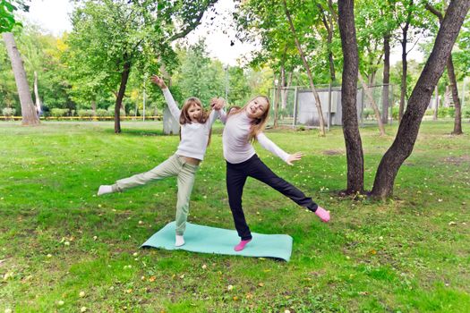 Photo of two playing girls in summer