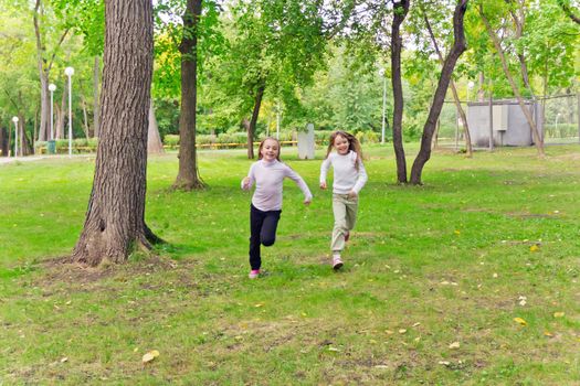 Photo of two running girls in summer