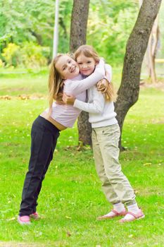 Photo of two playing girls in summer