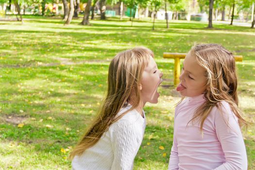 Photo of two playing girls in summer