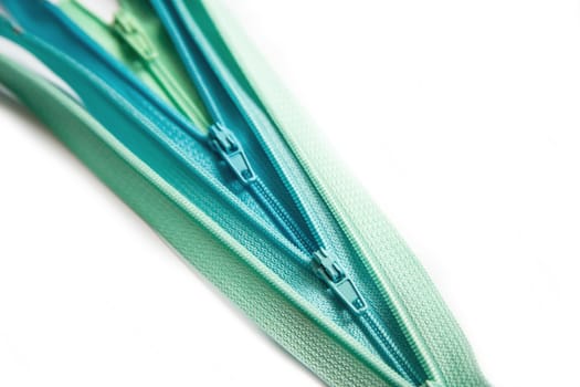 Open zipper green and blue pastel set isolated on white background