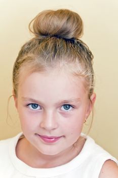 Cute girl with blond long hair and blue eyes