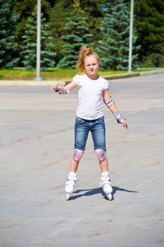 Photo of cute girl on roller skates in summer