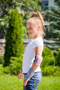 Photo of cute girl on roller skates in summer