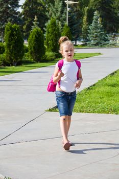 Cute girl go to school with pink knapsack