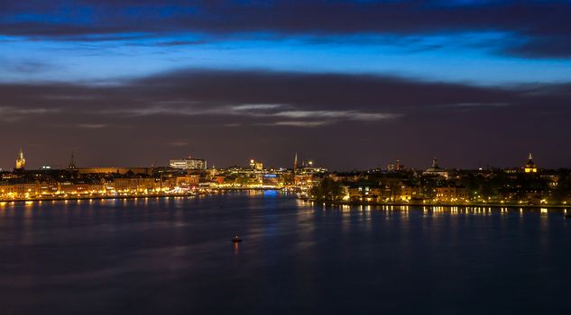 Stockholm cityscape at night with light reflection in water