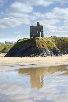 wild atlantic way castle and beach with beautiful reflection of the clouds