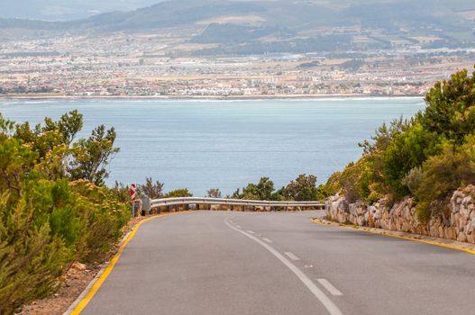 Road from the viewpoint at Steenbras Dam pump station in Gordons Bay near Cape Town, South Africa. Gordons Bay and Somerset West is in the distance