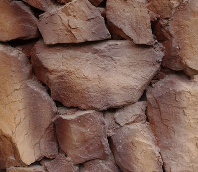 Background of stone wall texture, brown color in day time.                              