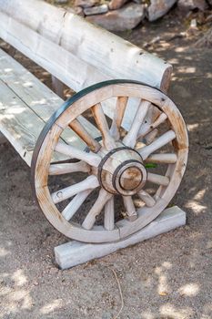 The antique bench made from wooden wheels