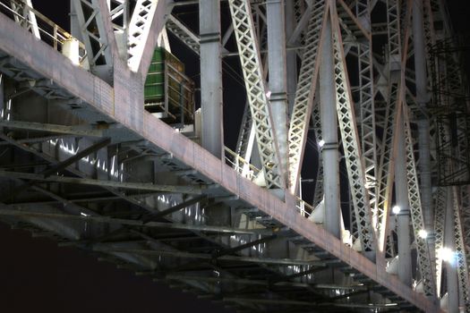 Supports of railway bridge, view from below, at night