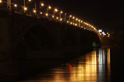Road bridge over the river at night