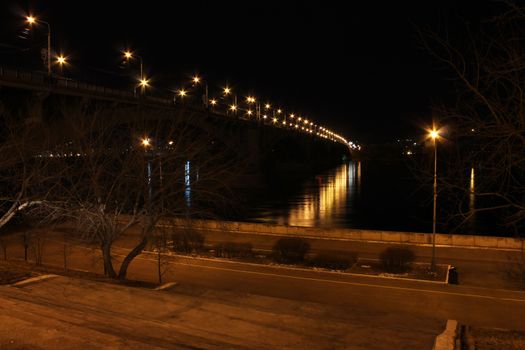 Road bridge over the river at night