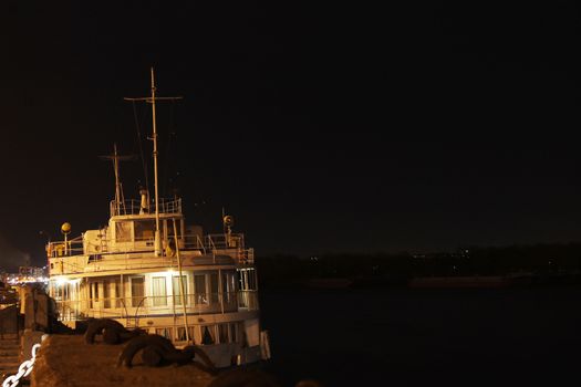 Motor ship standing on the river at night
