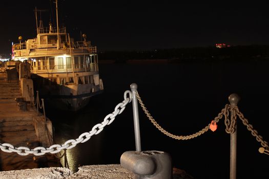 Motor ship standing on the river at night