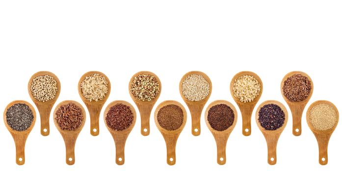 a variety of gluten free grains (buckwheat, amaranth, brown rice, millet, sorghum, teff, black, red, white and black quinoa, chia seeds, flax seeds) on wooden spoons isolated on white