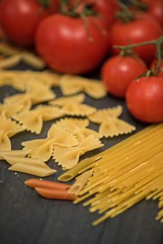 food background on rustic wood with pasta and tomatoes