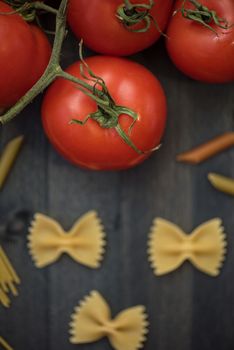 food background on rustic wood with pasta and tomatoes