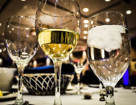 Glass of wine with water on served table. Restaurant