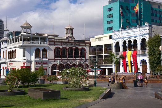 IQUIQUE, CHILE - JANUARY 22, 2015: Unidentified people on Plaza Prat main square with the buildings of Scotiabank, the Croatian Club and Casino Espanola on January 22, 2015 in Iquique, Chile. Iquique is a free port in Northern Chile.  