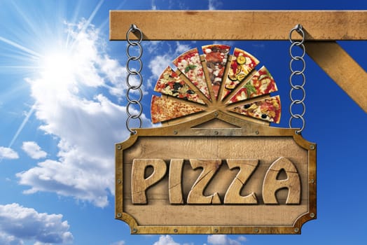 Wooden sign with metal frame and text pizza, slices of pizza on cutting board. Hanging from a chain on wooden pole on blue sky with clouds and sun rays