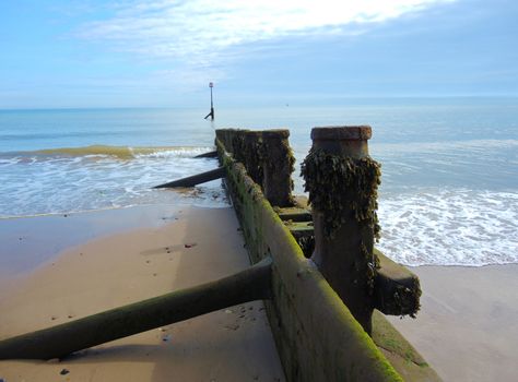 An image of Hornsea beach and showing a close-up of one the wooden breakwaters.