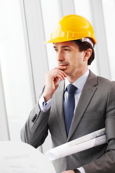 businessman in construction helmet thinking