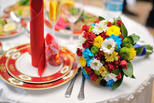 Colorful wedding bouquet lying on table in restaurant