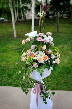Wedding arrangement of fresh flowers in summer park 