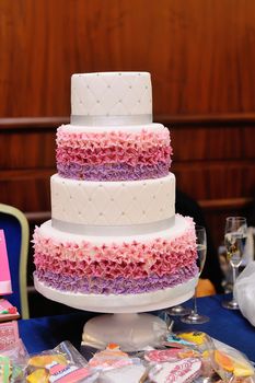 Wedding cake four tiers in restaurant on table