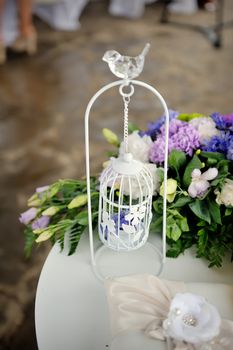 Wedding decor, white with a bird cage in restaurant