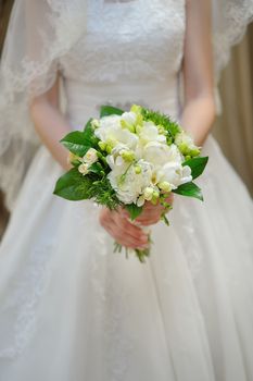 Beautiful wedding bouquet in hands of bride outdoor