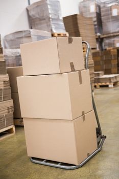 Cardboard boxes on trolley in warehouse