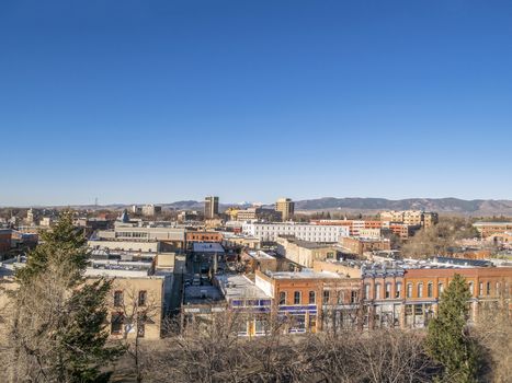 aerial view of Fort Collins downtown in sunrise light, shot from a low flying drone, early spring scenery under clear, blue sky