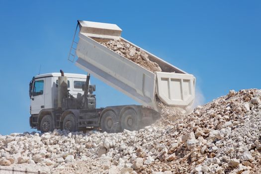 tipper truck unload crushed rocks