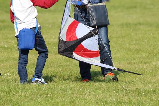A boy and his dad who prepare the kite