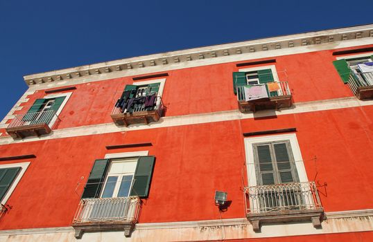 Italy. Campania region. Procida island. Mediterranean orange ochre house facade 